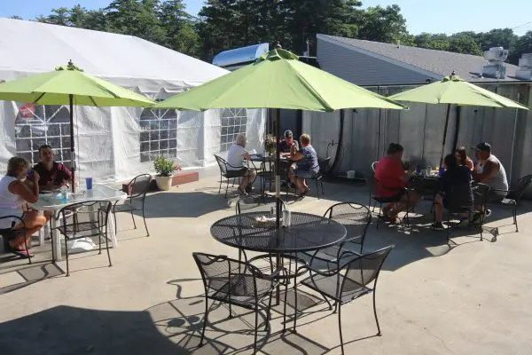 Patrons sitting under umbrellas at the outdoor dining areas